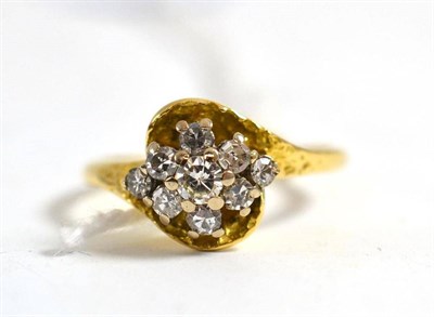 Lot 140 - An 18ct gold diamond cluster ring, set with a round brilliant cut diamond and eight-cut diamonds in