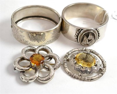 Lot 144 - Two Victorian bangles and two citrine set brooches