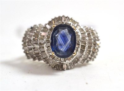 Lot 148 - A sapphire doublet and diamond cluster ring, the oval mixed cut doublet in a white four claw...