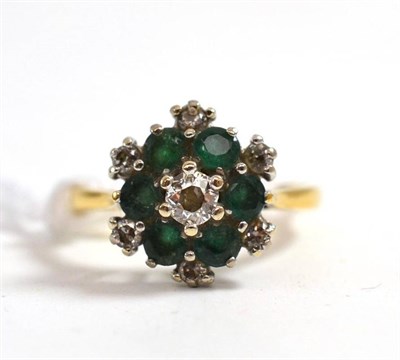 Lot 149 - An 18ct gold diamond and emerald cluster ring, total estimated diamond weight 0.35 carat...