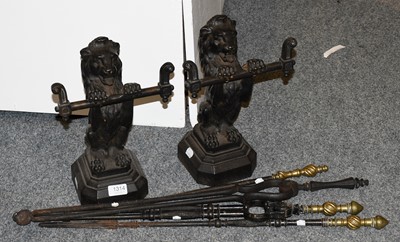 Lot 1314 - A Pair of Lion Form Andirons and Four Fire Tools