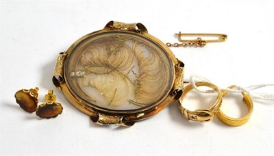 Lot 152 - A mourning brooch inset with hair, a buckle ring, a pair of earrings and an odd hoop earring