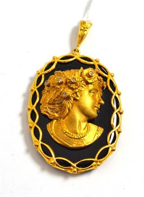 Lot 156 - A 9ct gold diamond set maiden's head pendant on onyx mount