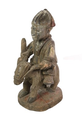 Lot 224 - A Yoruba Carved Wood Figure, Nigeria, as a man...