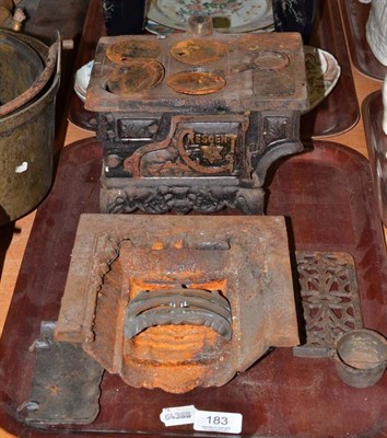 Lot 183 - A cast iron toy cooking range and fireplace (2)