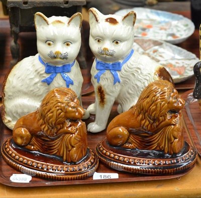 Lot 186 - A pair of saltglaze stoneware recumbent lions and a pair of Staffordshire pottery cats