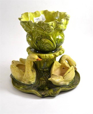 Lot 191 - A Bretby green pottery table centrepiece as swans amidst foliage