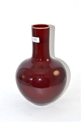 Lot 193 - A burgundy glazed onion shaped bottle vase