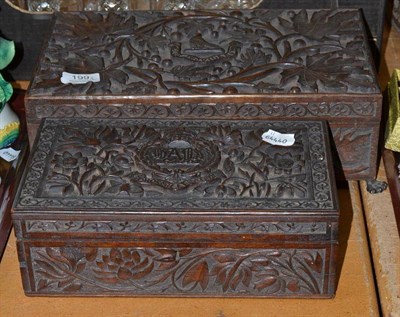 Lot 199 - An Indian teak cigarette box carved with a regimental badges of the Bays; a similar large box,...