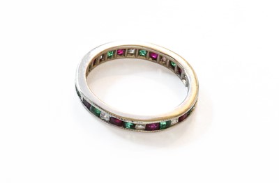 Lot 130 - An Emerald, Diamond and Ruby Eternity Ring,...