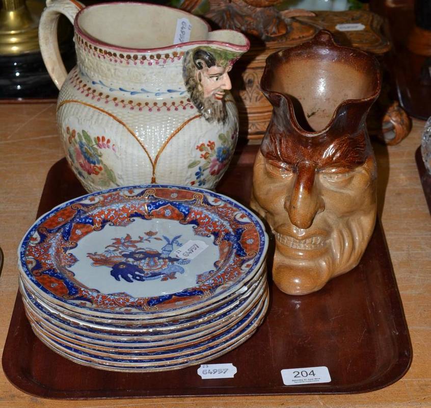 Lot 204 - A Victorian saltglaze stoneware grotesque mask jug; a set of nine Spode New Stone dessert plates; a