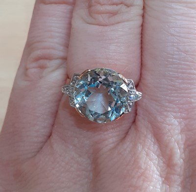 Lot 2046 - An Aquamarine and Diamond Ring the round cut...