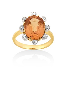 Lot 2068 - A Topaz and Diamond Cluster Ring the oval cut...