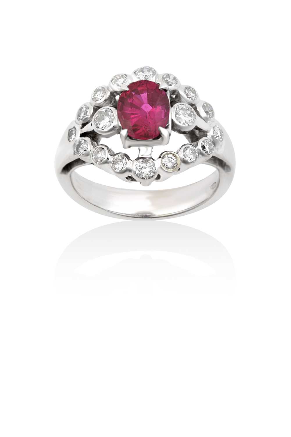 Lot 2085 - A Ruby and Diamond Cluster Ring the oval cut...