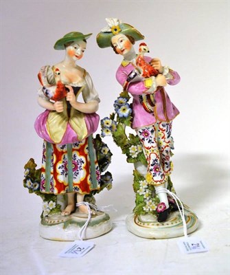 Lot 21 - A Pair of Derby Porcelain Figures of a Lady and Gentleman, circa 1770, both standing holding exotic