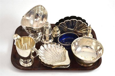 Lot 219 - A collection of silver comprising sugar basin, two shell butter dishes, cream jug, three...