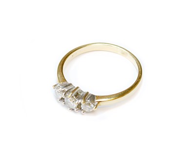Lot 132 - A Diamond Three Stone Ring, stamped '750' and '...