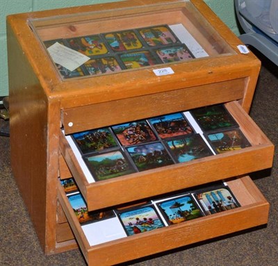 Lot 228 - Assorted magic lantern slides in a glazed top case with drawers