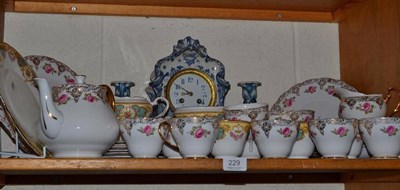 Lot 229 - Composite rose decorated tea set; Continental blue and white pottery cased mantel clock, Japy...