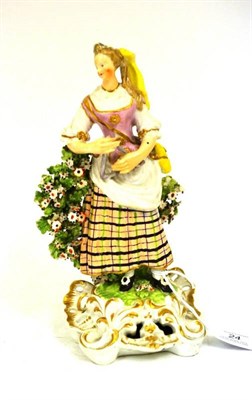 Lot 24 - A Derby Porcelain Figure of a Female Musician, circa 1770, standing wearing a yellow headdress...