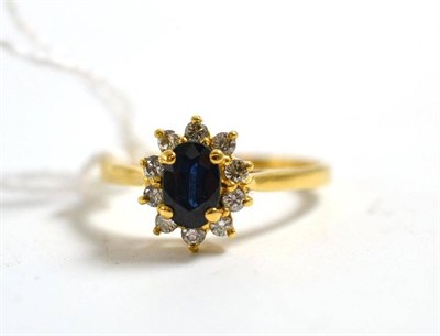 Lot 242 - A sapphire and diamond cluster ring