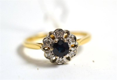 Lot 244 - A sapphire and diamond cluster ring