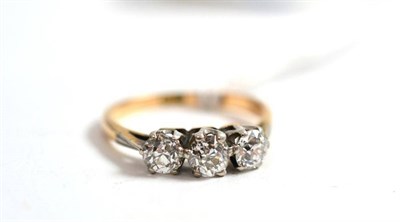 Lot 259 - A diamond three stone ring, circa 1930, the old cut diamonds in white claw settings on white...