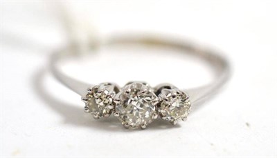 Lot 263 - A diamond three stone ring, the graduated old cut diamonds in a white gold claw setting, on a...