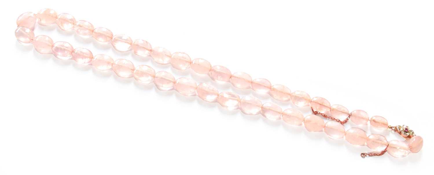 Lot 56 - A Rose Quartz Bead Necklace, knotted to a...