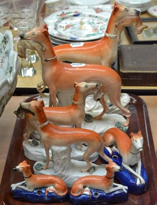 Lot 307 - Two pairs of Staffordshire figures of standing greyhounds and a graduated set of three...