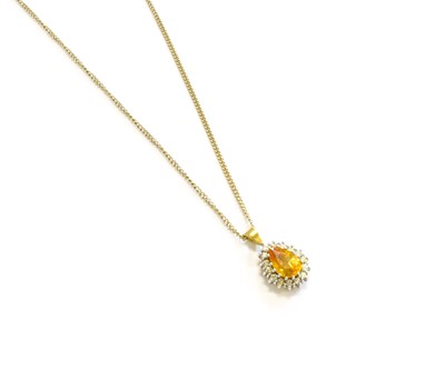 Lot 262 - A Yellow Sapphire and Diamond Cluster Pendant...