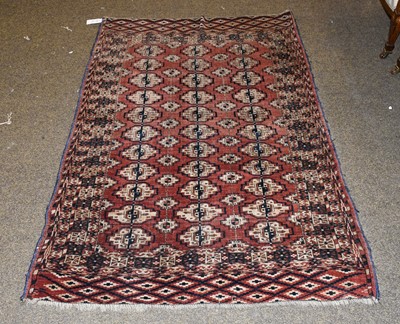 Lot 1100 - A Tekke Rug, the madder field with four rows...