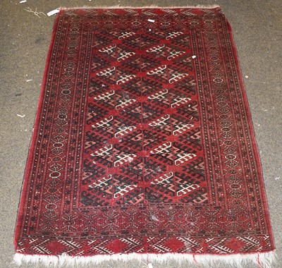 Lot 1101 - An Afghan Tekke Rug, the claret field of...