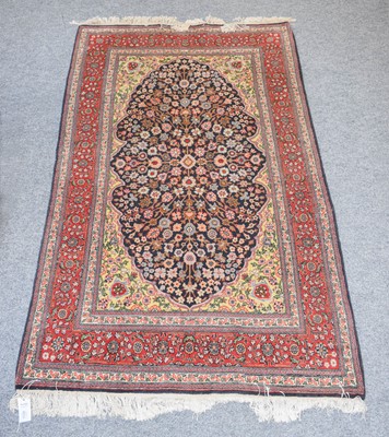 Lot 1108 - An Anatolian Rug, the indigo floral field...