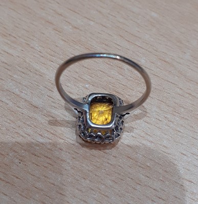 Lot 2054 - A Yellow Sapphire and Diamond Cluster Ring the...