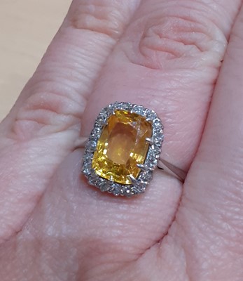 Lot 2054 - A Yellow Sapphire and Diamond Cluster Ring the...