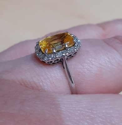 Lot 2054 - A Yellow Sapphire and Diamond Cluster Ring the...