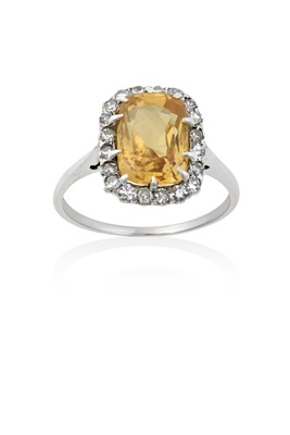 Lot 2054 - A Yellow Sapphire and Diamond Cluster Ring the...