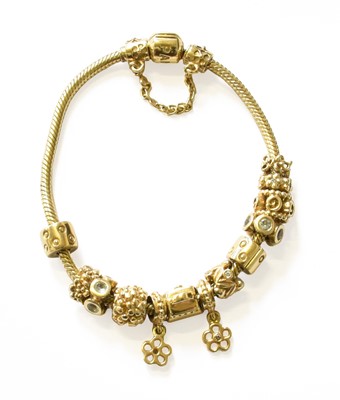 Lot 229 - A 14 Carat Gold Pandora Bracelet, hung with...