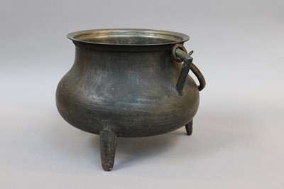 Lot 254 - A Patinated Metal Cauldron, with swing handle...