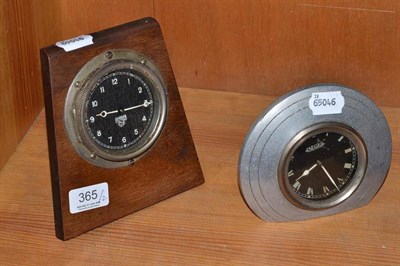 Lot 365 - A Jaeger dashboard clock in an aluminium mount and a Smiths dashboard clock in a wooden frame