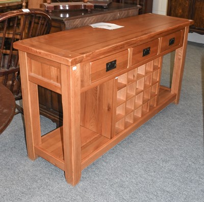 Lot 1148 - A Modern Oak Three Drawer Sideboard, with...