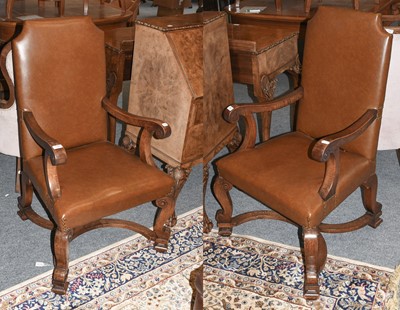 Lot 1242 - A Pair of Oak and Leather Open Armchairs, in...