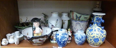 Lot 375 - A shelf of decorative ceramics including ginger jars, Toby jugs, a Worcester style punch bowl,...