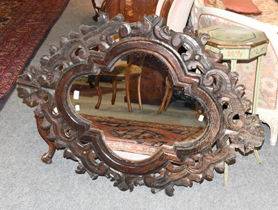 Lot 1410 - A Carved Oak Wall Mirror, the quatrefoil plate...