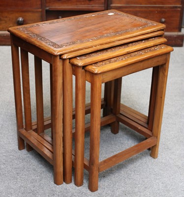 Lot 1235 - A Nest of Four Carved Teak Tables, largest,...