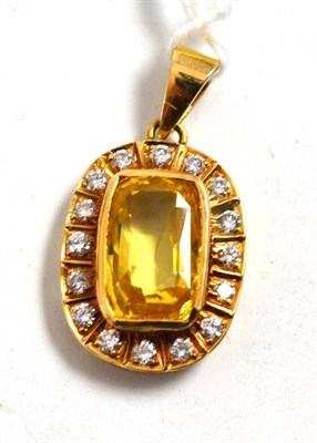 Lot 401 - A yellow synthetic sapphire and diamond cluster pendant, the cushion shaped mixed cut sapphire in a