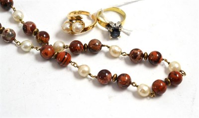 Lot 402 - Two 14ct gold rings and a string of beads