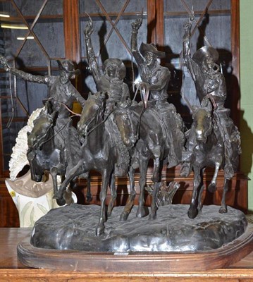 Lot 418 - After Frederic Remington, a large bronze figure group of four cowboys