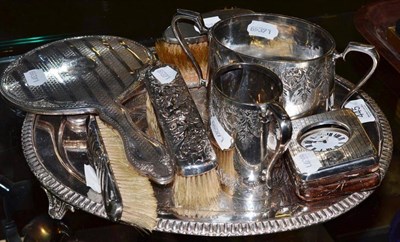 Lot 445 - Silver watch case, four silver backed brushes and a mirror, plated salver, sugar and milk jug (9)